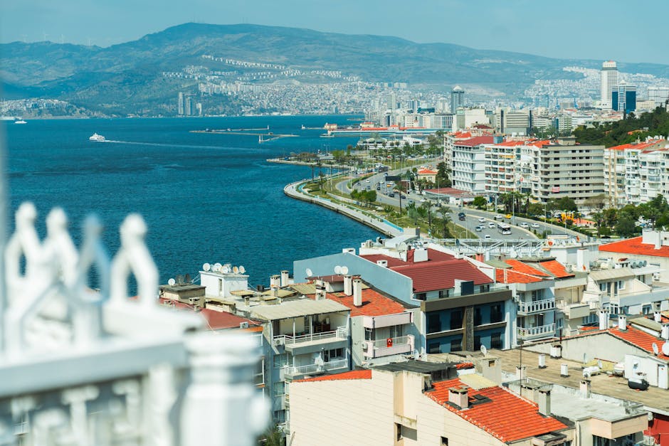 Aerial view of Izmir's coastline featuring vibrant buildings and the Aegean Sea.