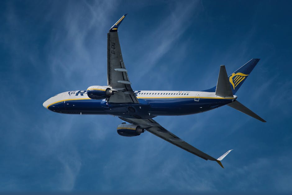 A commercial jet airliner soaring through a clear blue sky, showcasing flight and travel.